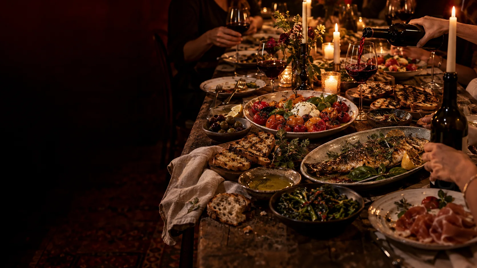 Friends sharing an abundant candlelit dinner